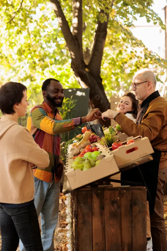 African guy trying out organic produce at farmers market